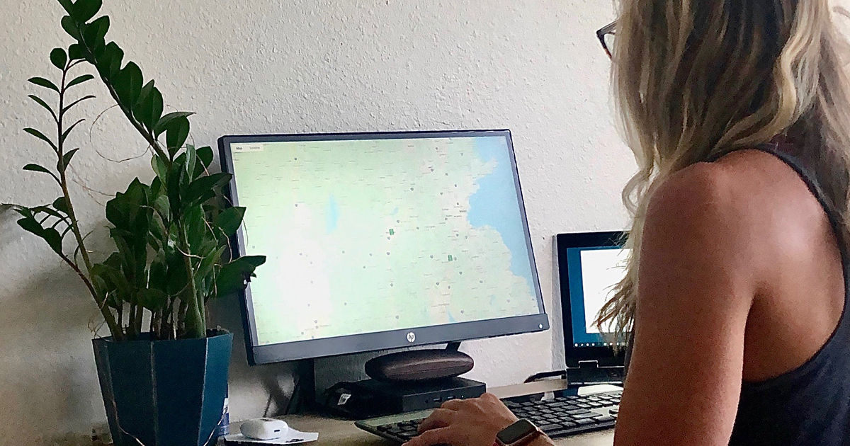 Woman looking at a map on a computer monitor